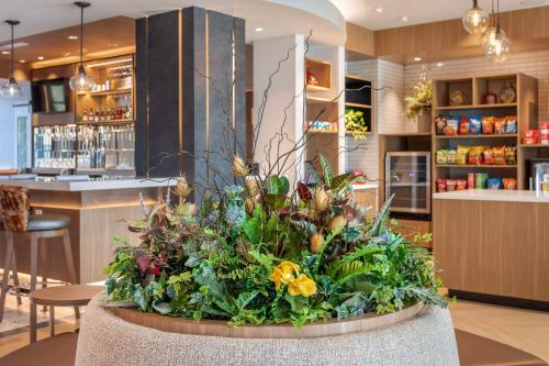 a large flower arrangement in the lobby of a restaurant at Cambria Hotel Pigeon Forge in Pigeon Forge