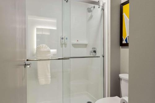 a bathroom with a glass shower with a toilet at Comfort Inn Conroe in Conroe