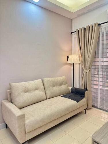 a couch in a living room with a window at Villa 2bedroom 14min Sutera Mall&Paradigm&Legoland&5min Xin Wan Chay in Johor Bahru