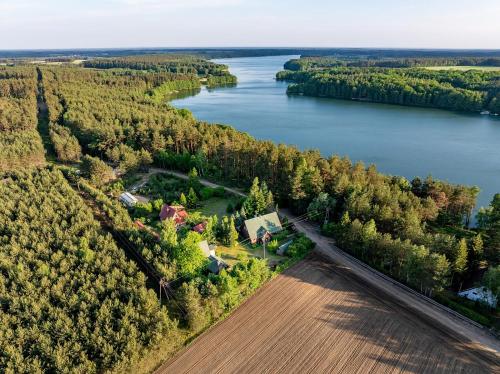 an aerial view of a house next to a river at Chaty Kaszubskie in Łąkie
