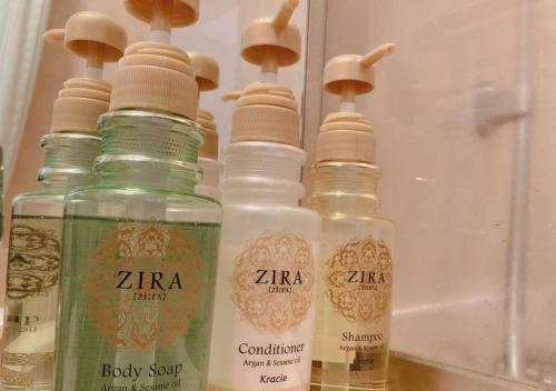 a group of four bottles sitting on top of a counter at Business Inn Norte in Sapporo
