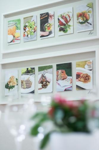 a wall with pictures of food on it at Villa Bucher - Metnitztalerhof in Friesach