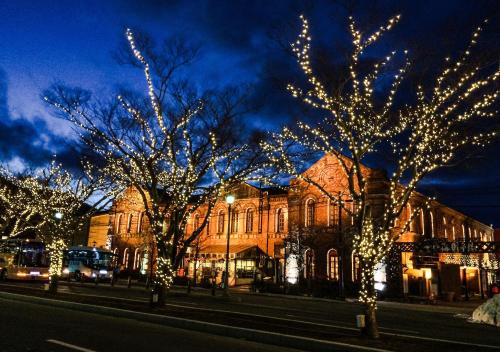 a street with trees decorated with christmas lights at Tasogare Apartment 101 in Hakodate