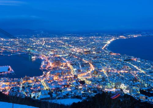 an aerial view of a city at night at Tasogare Apartment 101 in Hakodate