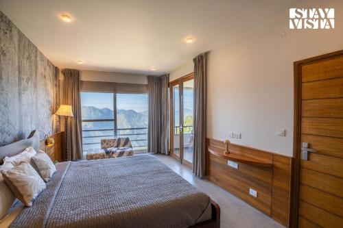 a bedroom with a bed and a window with a view at StayVista at Grove - Elysium Estate with Hill View, Lawn in Shimla