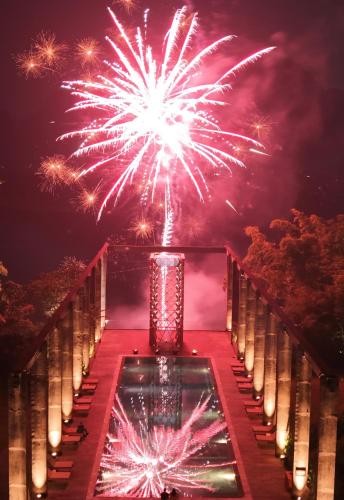 a firework display over a pool at night at Yangshuo Sugar House in Yangshuo
