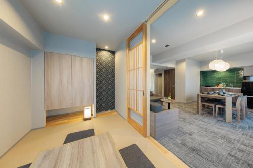 a living room with a table and a dining room at Minn Kiyomizu Gojo in Kyoto