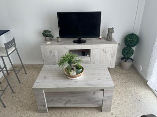 a living room with a tv and a wooden coffee table at San Mateo Loft in Tarifa