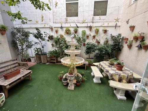 a courtyard with a fountain with benches and potted plants at San Mateo Loft in Tarifa