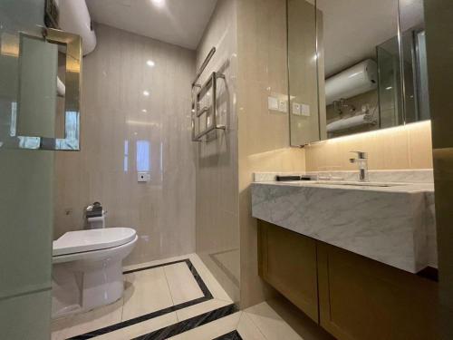 a bathroom with a white toilet and a sink at Shanghai Lerongju Boutique Apartment Metro Line 8 20meter in Shanghai
