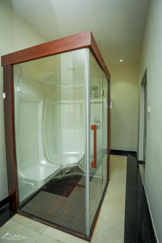 a large glass enclosure with a red item in it at The Grand Mountain Hotel in Matale