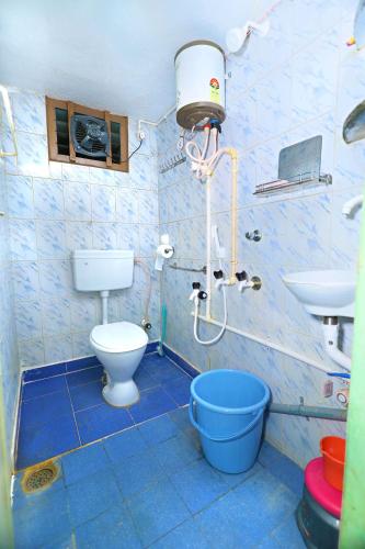 a bathroom with a toilet and a sink at Manohar's Homestay in Tirupati