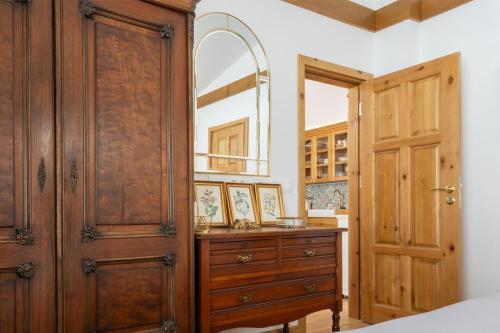a bedroom with a dresser and a wooden door at Villa Eliyas with Jacuzzi near the Pirin Golf Resort in Razlog