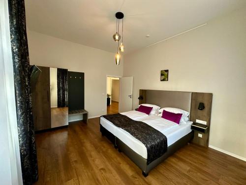 a bedroom with a large bed with red pillows at Residence Black Eagle Lubmin Strand in Lubmin