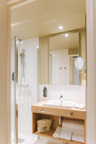 a bathroom with a sink and a mirror at Bikube Lyon in Lyon