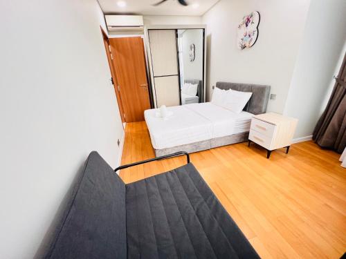 a small room with a bed and a chair at Sky Suites at KLCC by Mitstay in Kuala Lumpur