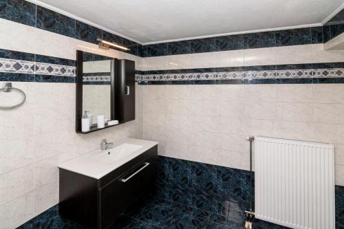a bathroom with a sink and a mirror at Martas Dream - Near Beach Apartments in Daratso
