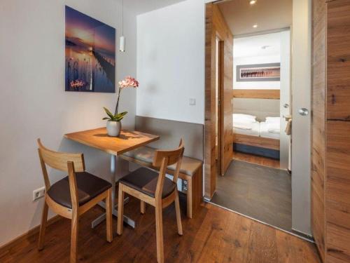 a dining room with a table and chairs and a bedroom at Gasthaus Seeblick in Hagnau