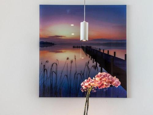 a painting of a pier and a flower on a wall at Gasthaus Seeblick in Hagnau