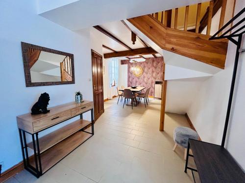 a living room with a table and a mirror at L'Envol - Spacieuse maison avec piscine privative in Champagne