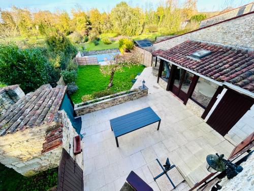 an overhead view of a patio with a blue bench at L'Envol - Spacieuse maison avec piscine privative in Champagne