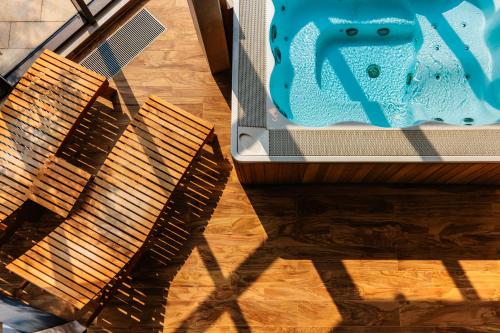 two wooden benches sitting on a wooden floor with a bath tub at Camping Stobreč Split in Split