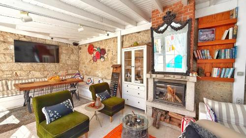 a living room with a fireplace and a table and chairs at Jardin d'Azur Alaçatı in Alacati