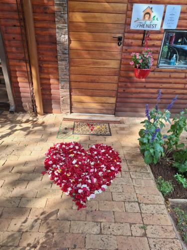 a heart made out of flowers on a patio at Tree Living in Krugersdorp