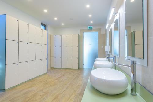 a bathroom with four sinks and a mirror at Camping Stobreč Split in Split
