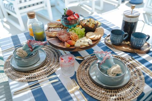 a blue and white table with plates of food at Last Word Long Beach in Kommetjie