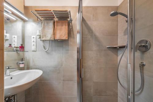 a bathroom with a shower and a sink at Austillerhof - Urlaub auf dem Bauernhof in Funes