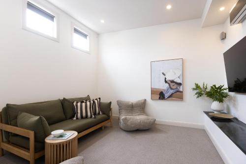 a living room with a couch and a table at Pleasant View Stays TORQUAY in Torquay