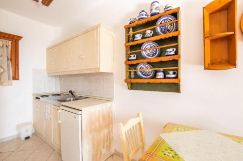 a kitchen with a white refrigerator and a counter top at Arhontiko Hotel in Foinikion