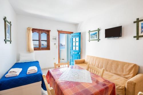 a living room with a couch and a table at Arhontiko Hotel in Foinikion