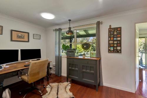 a home office with a desk and a window at Lumeah by the Creek in Whian Whian