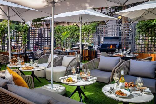 a restaurant with tables and chairs and a fireplace at Taj Cape Town in Cape Town