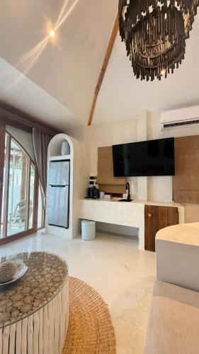 a living room with a table and a tv at Cape Beach Villa Samui in Ban Bang Po