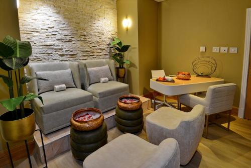 a living room with a couch and chairs and a table at Taj Cape Town in Cape Town