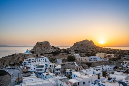 a view of a town with the sunset in the background at Arhontiko Hotel in Foinikion
