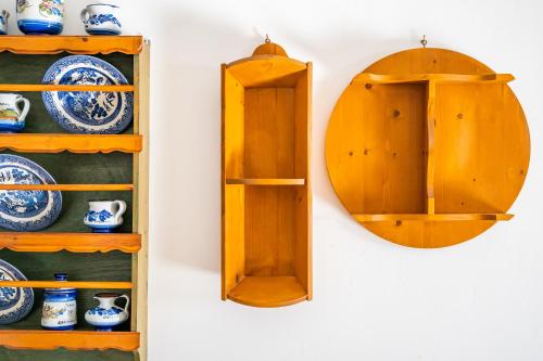 a mirror hanging on a wall next to a shelf at Arhontiko Hotel in Foinikion