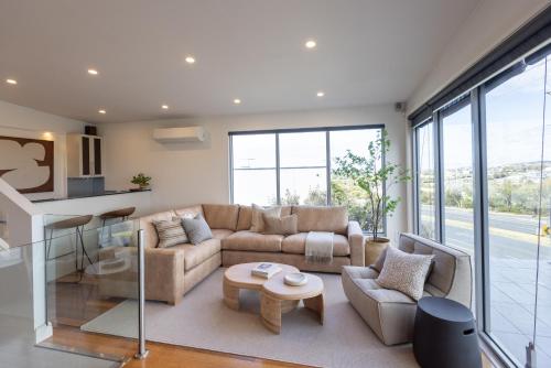 a living room with a couch and a table at Pleasant View Stays TORQUAY in Torquay