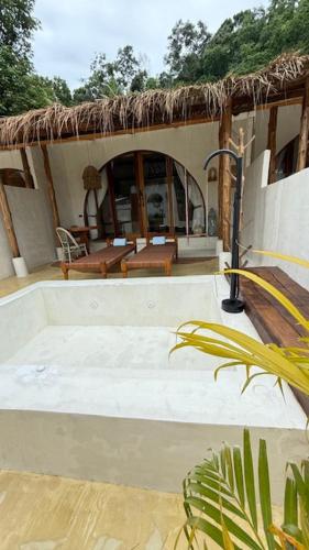 a porch of a house with a table and chairs at Cape Beach Villa Samui in Ban Bang Po