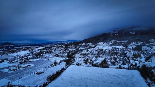 an aerial view of a city covered in snow at CsillaG Apartman in Kisapáti