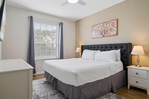 a bedroom with a large bed and a window at 4024 Breakview Drive 303 in Orlando