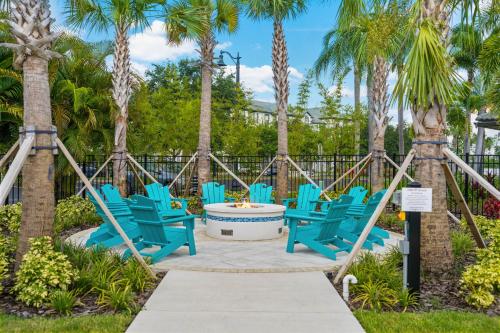 a group of blue chairs on a patio with palm trees at 4024 Breakview Drive 303 in Orlando