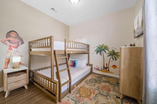 a bedroom with two bunk beds and a mural at 4024 Breakview Drive 303 in Orlando
