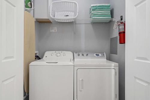 a small kitchen with a white stove and a washer at 4024 Breakview Drive 303 in Orlando