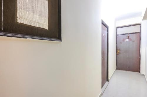 a hallway with a door and a picture on the wall at Hotel O Royal Residenc in Indirapuram