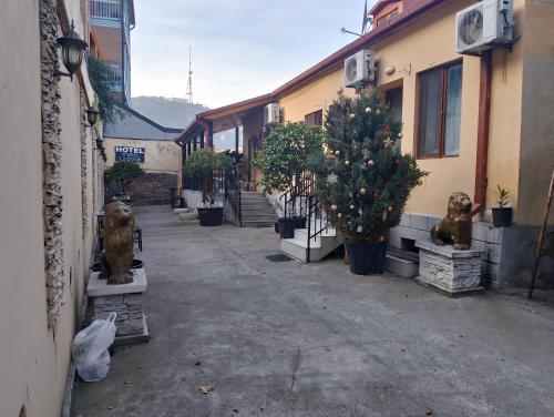 a street with a christmas tree and some buildings at Two Lions Hotel in Tbilisi City