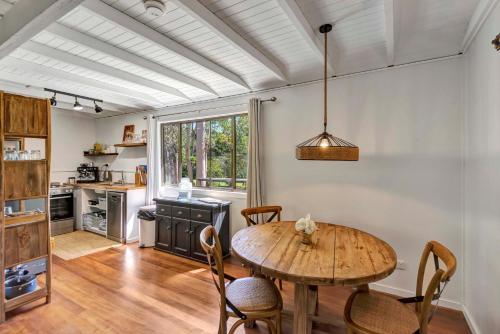 a kitchen with a table and chairs in a room at Lumeah by the Creek in Whian Whian